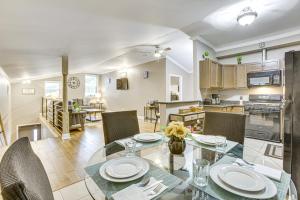a dining room and kitchen with a glass table and chairs at Walk to Canal St Trolley! Mid-City NOLA Retreat in New Orleans