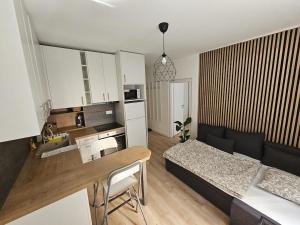 a living room with a bed and a dining room at Apartment Park - Air-conditioned in Šamorín