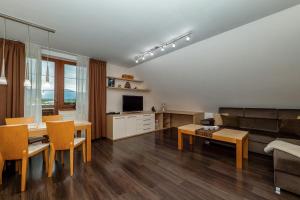 a living room with a couch and a table at Apartmán SkyNest Tatry - Veľká Lomnica in Veľká Lomnica