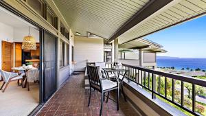 a balcony with a table and chairs and the ocean at Kapalua Ridge Villa 1624 in Kapalua