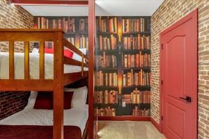 a bedroom with a bunk bed and a book shelf filled with books at Luxury e Themed Rooms Minutes from Disney Parks in Kissimmee