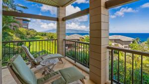 a balcony with chairs and a view of the ocean at Kapalua Ridge Villa 1112 in Kapalua