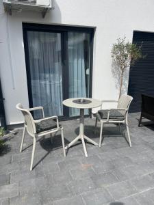 a patio with a table and two chairs and a table at Studio8 centerapartment Prizren in Prizren