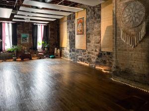 a room with a wooden floor and a brick wall at Swedetown European Style Hostel by Heirloom Boutique Collection in Duluth
