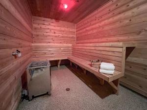 a wooden sauna with a bench and a stove at Swedetown European Style Hostel by Heirloom Boutique Collection in Duluth