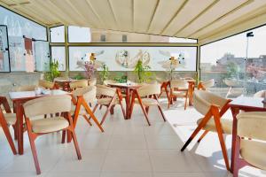 a restaurant with tables and chairs in a room at Dar Atom pyramids in Cairo
