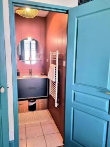 a bathroom with a sink and a mirror at Le Globe Trotters in Saint-Étienne +20 photos