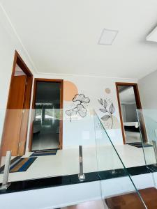 a room with a glass staircase with two mirrors at Casa de praia SANTINHO in Búzios
