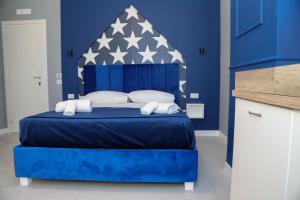 a blue bedroom with a blue bed with an american flag on it at Dello Iacono suite in Naples