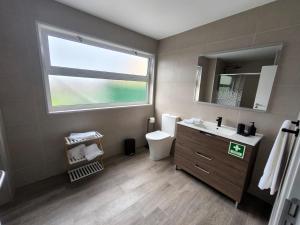 a bathroom with a sink and a toilet and a window at Flor da Natureza - Flor in Pilar +9 photos