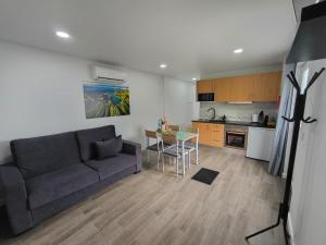 a living room with a couch and a table at Flor da Natureza - Flor in Pilar