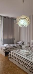 two beds sitting next to each other in a room at PRATE48 in Bologna