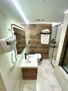 Un baño con lavabo, ducha e inodoro. en Platinum pyramids View INN, en El Cairo 46 fotos más