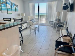 a living room with a view of the ocean at Ocean Walk Resort - Spectacular Ocean Front View in Daytona Beach