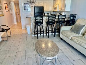 a living room with a couch and a table at Ocean Walk Resort - Spectacular Ocean Front View in Daytona Beach