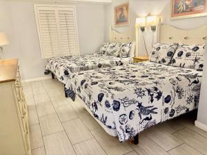 a bedroom with two beds and a table at Ocean Walk Resort - Spectacular Ocean Front View in Daytona Beach +45 photos