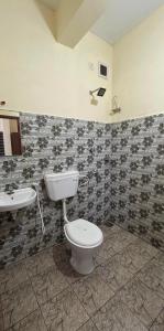 a bathroom with a toilet and a sink at Casa Grand in Alwaye +36 photos