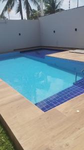 a large swimming pool with blue water at Casa de praia-Barra de são Miguel in Barra de São Miguel