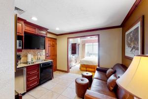 a living room with a couch and a kitchen with a bed at Westgate Charm #4814B in Park City