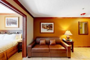 a hotel room with a bed and a leather chair at Westgate Charm #4814B in Park City