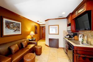 a living room with a couch and a kitchen with a sink at Westgate Charm #4814B in Park City +26 photos