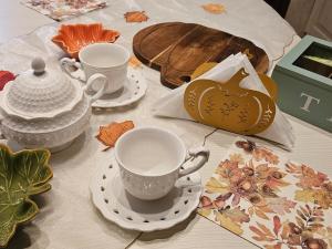 a table with two cups and saucers on it at Da Caterina alla piccola cascata in Antrodoco +73 photos