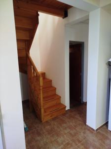 a stairwell in a house with wooden stairs at La Torre Departamento in Caleta Olivia
