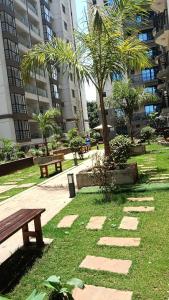 a park with benches and palm trees in a city at Quick Connect Studio Kileleshwa in Nairobi