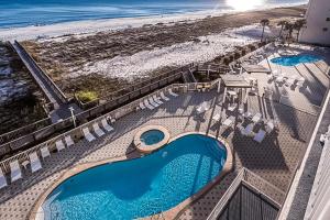 an overhead view of a swimming pool and the beach at Summerwind 0402 in Navarre