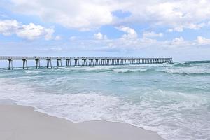 a pier stretches out over the ocean with waves at Summerwind 0402 in Navarre