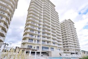 a large apartment building with a pool in front of it at Summerwind 0402 in Navarre +19 photos