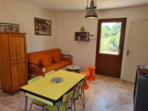 a living room with a table and a couch at La Chalan d'hier in Nort-sur-Erdre