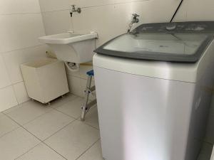 a bathroom with a sink and a toilet at Cantinho da Barra in Barra dos Coqueiros +6 photos