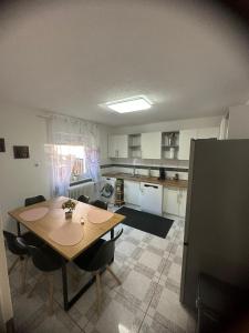 a kitchen with a table and chairs in a room at Ferienwohnung Schwarzwälder Tulpe in Gernsbach +20 photos