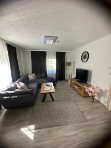 a living room with a couch and a table at Ferienwohnung Schwarzwälder Tulpe in Gernsbach