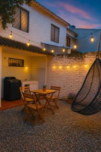 a patio with a hammock and a table and chairs at Ana home in Neiva +9 photos