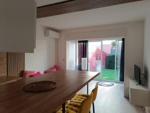 a dining room with a large wooden table and chairs at Beautiful apartment with direct beach access in Sète