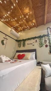 a bedroom with a white bed with lights on the wall at Recanto Vista Verde in Nova Petrópolis
