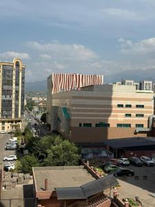 a large building with a red and white roof at spacious apartment in Almaty