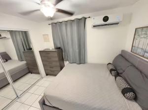 a living room with a couch and a ceiling fan at Vacation Rental Ceiba PR B16 in Ceiba