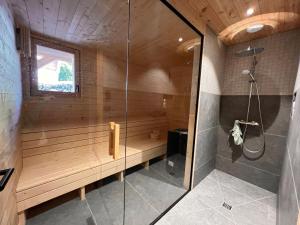a bathroom with a sauna with a bench and a shower at Chalet les 3 Montagnards - 200m des pistes in Montgenèvre +20 photos