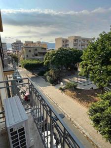 a balcony with a bench on a city street at Casamore in Villa San Giovanni