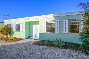 Conch KeyFisherman's Hideaway的绿色白色的房屋,有车道