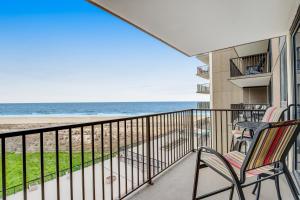 a balcony with chairs and a view of the beach at Sea Colony - 505 Chesapeake House Rd in Sea Colony