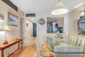 a dining room and kitchen with a glass table and chairs at Sea Colony - 505 Chesapeake House Rd in Sea Colony