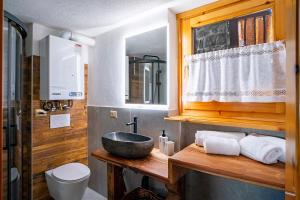 a bathroom with a sink and a toilet at Le Mayen in Valtournenche