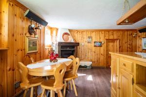 a dining room with a wooden table and chairs at Le Mayen in Valtournenche