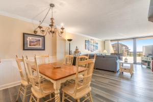 a dining room and living room with a table and chairs at Sea Colony - 107 Chesapeake House Rd in Sea Colony