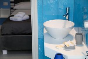 a bathroom with a white bowl sink on a counter at Dello Iacono suite in Naples +50 photos