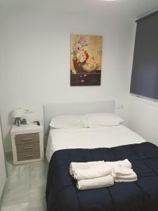 En eller flere senge i et værelse på Ático Cassinello Roquetas